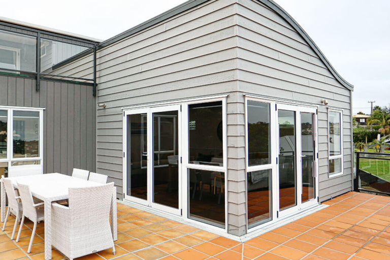 Aluminium window frames repainted in a clean modern white.