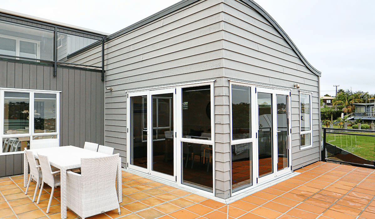 Aluminium window frames repainted in a clean modern white.