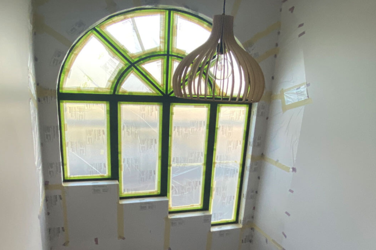 Arch window frames prepped for painting